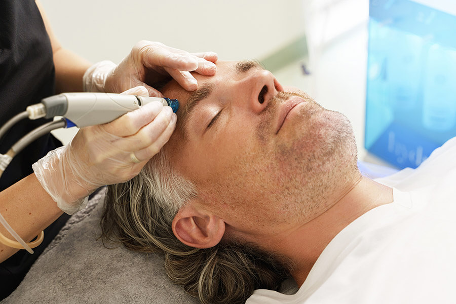 A male client undergoing HydraFacial Treatment.