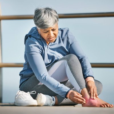 Foot, pain and old woman with injury, fitness outdoor and medical emergency and inflammation with red overlay. Muscle tension, osteoporosis or fibromyalgia with health, exercise and female person
