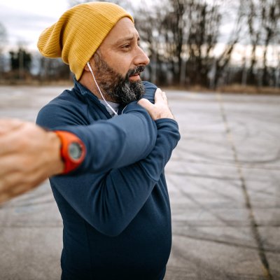 Mature man stretching before running