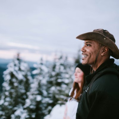 Hikers Look At View of Snow Covered Pacific Northwest