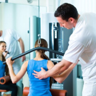 Patient at the physiotherapy making physical exercises with her therapist